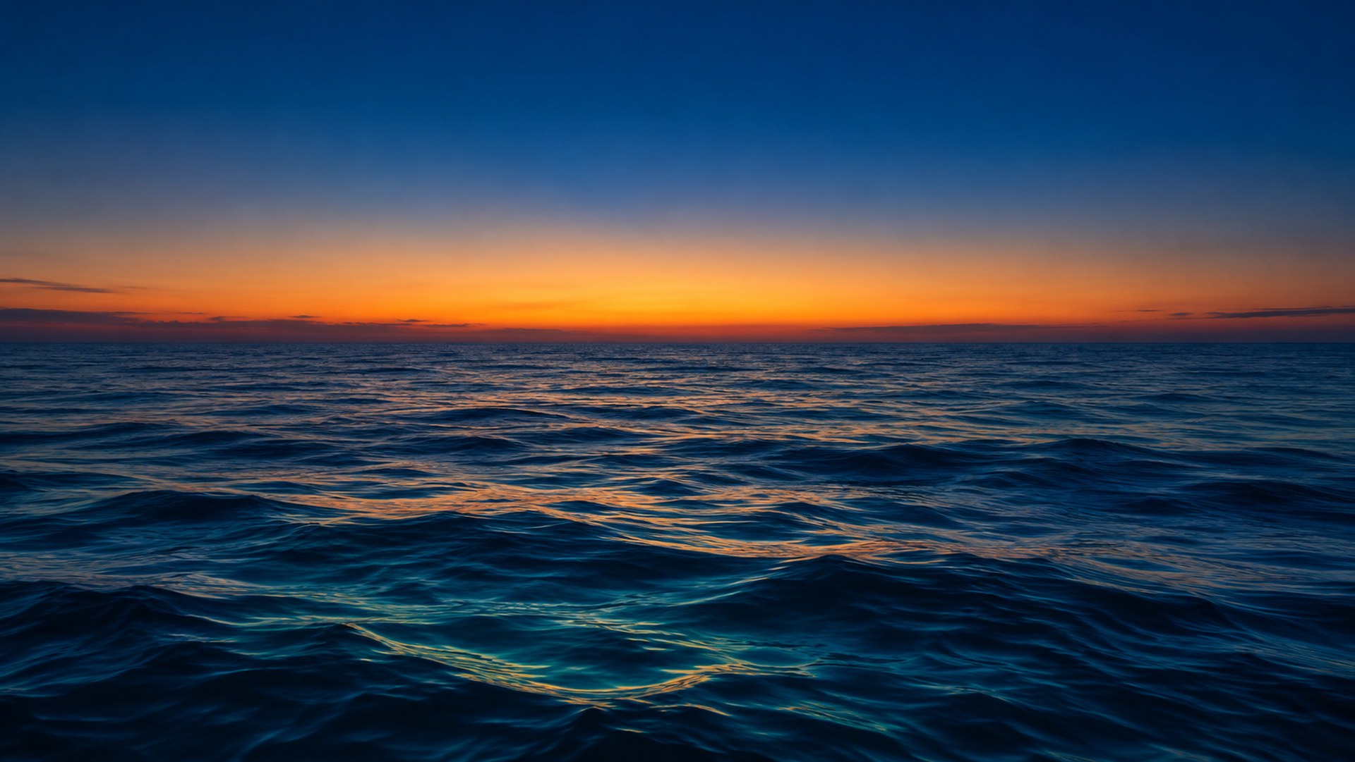 The open sea a few minutes after sunset, a last golden glow along the horizon